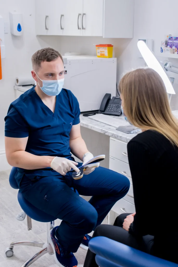 Insole fitting patient discusses with Joe narrow shot
