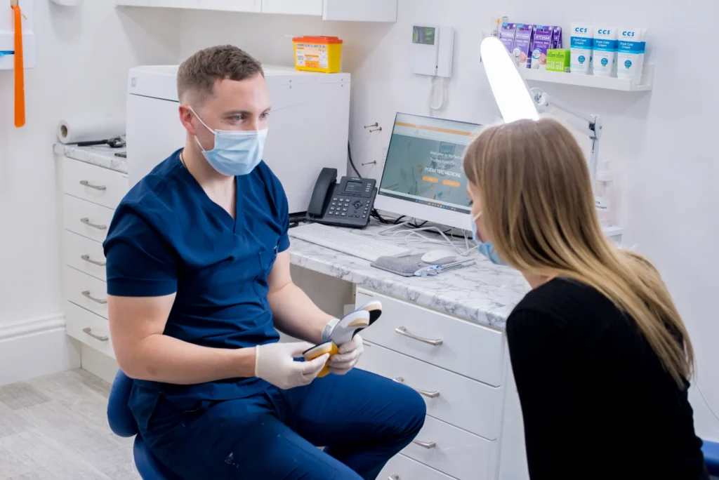 Insole fitting patient discusses with Joe wideshot